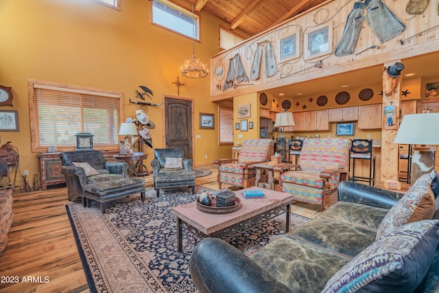 living room with an inviting chandelier, wood ceiling, high vaulted ceiling, and light wood-type flooring