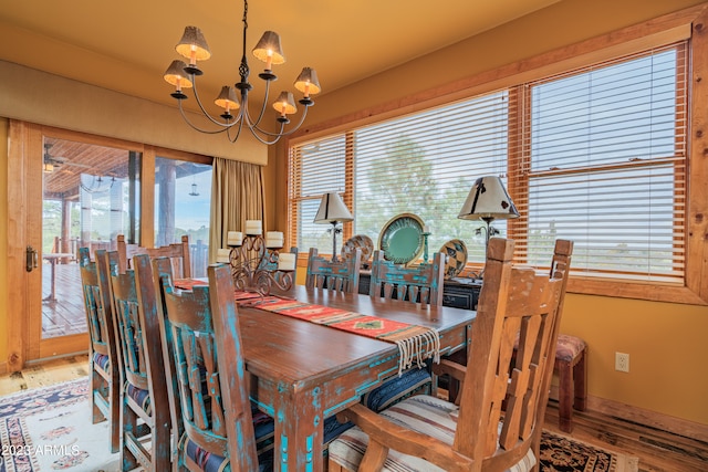 dining space featuring a chandelier and wood-type flooring