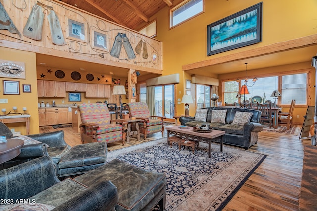 living room with beamed ceiling, an inviting chandelier, high vaulted ceiling, wood ceiling, and hardwood / wood-style flooring