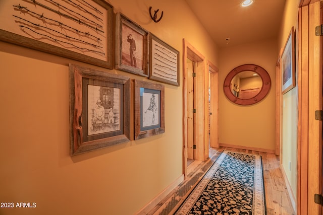 hallway with light hardwood / wood-style flooring