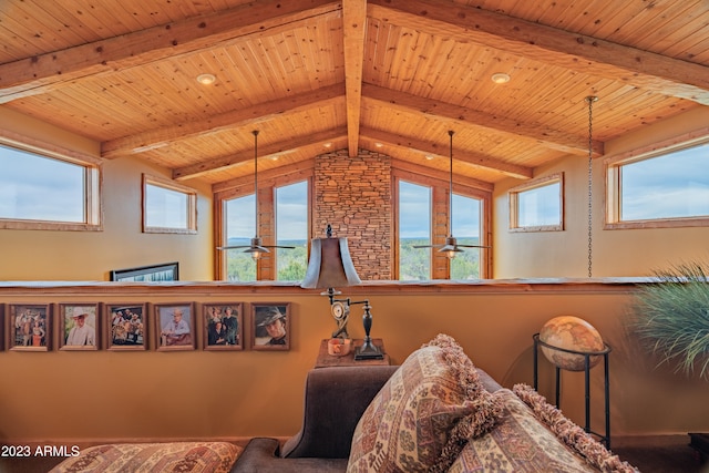 interior space with plenty of natural light, ceiling fan, and beamed ceiling