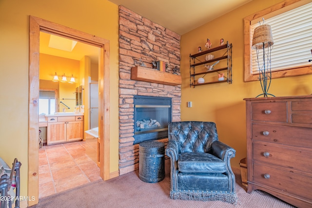 living area featuring a fireplace and light colored carpet