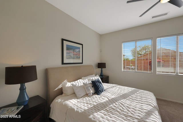 carpeted bedroom featuring lofted ceiling, visible vents, ceiling fan, and baseboards