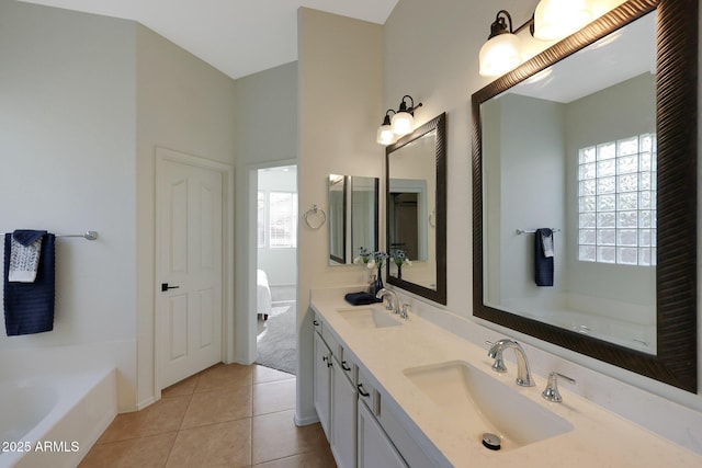 full bath with a healthy amount of sunlight, a sink, and tile patterned floors