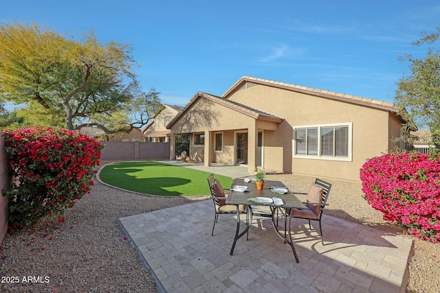 back of property featuring a patio area, fence, and stucco siding