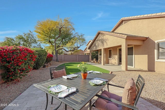 view of patio with a fenced backyard and outdoor dining area