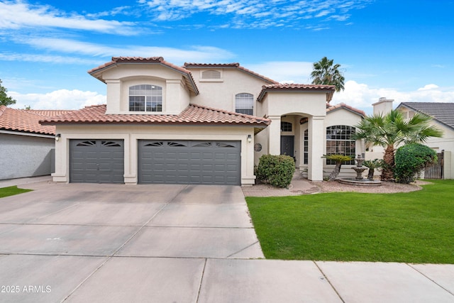 mediterranean / spanish house featuring an attached garage, concrete driveway, a tiled roof, stucco siding, and a front lawn