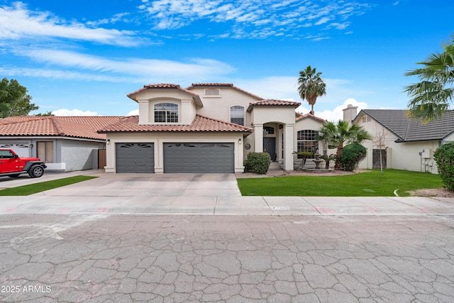 mediterranean / spanish-style house featuring a garage, concrete driveway, stucco siding, a tiled roof, and a front yard