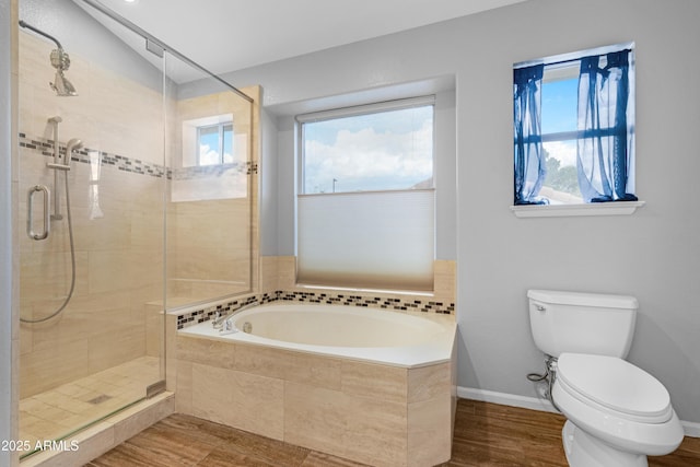 full bath featuring baseboards, toilet, wood finished floors, a garden tub, and a shower stall