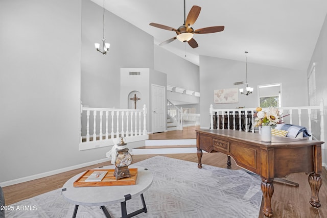 interior space with baseboards, stairs, visible vents, and wood finished floors