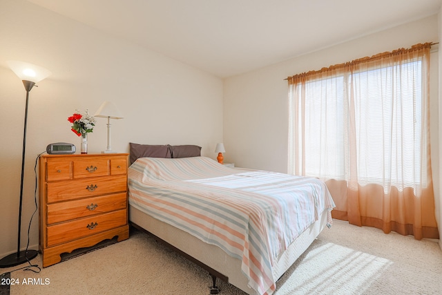 carpeted bedroom featuring multiple windows