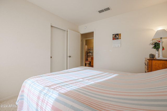 carpeted bedroom with a closet