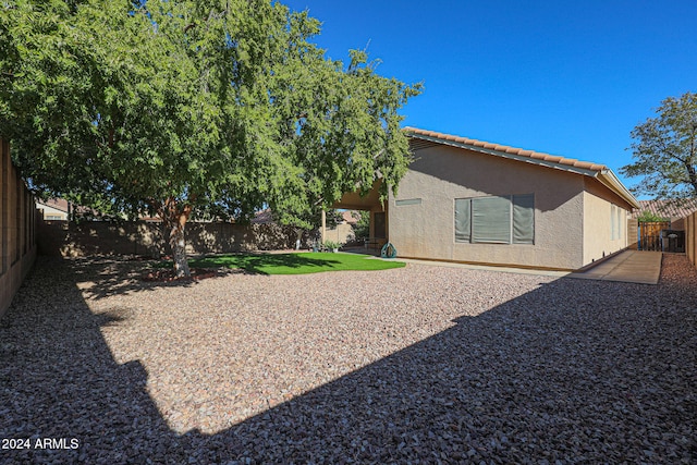 rear view of property featuring a patio area