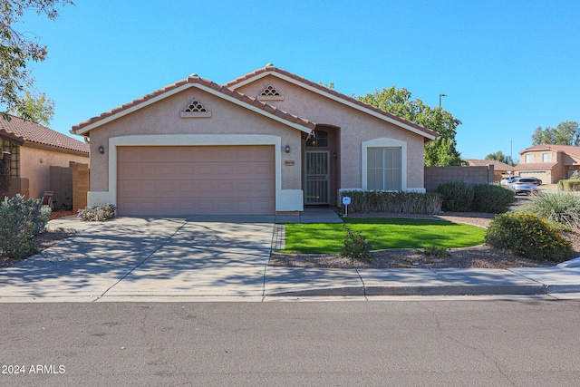 view of front of home featuring a garage and a front lawn