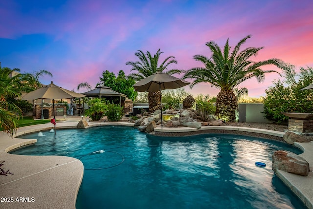 pool with a gazebo and a patio area