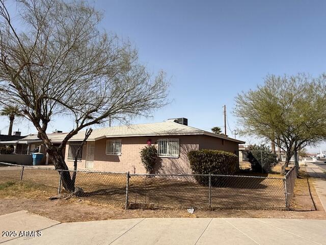 view of property exterior featuring a fenced front yard