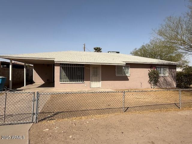 view of property exterior featuring fence and an attached carport