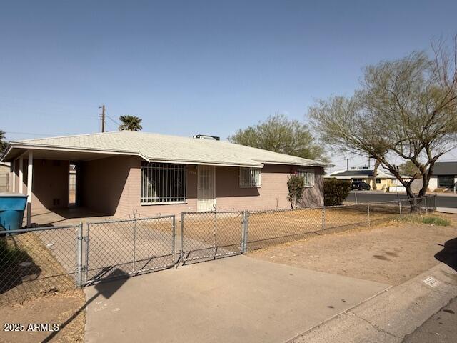 view of front facade featuring a fenced front yard and a gate