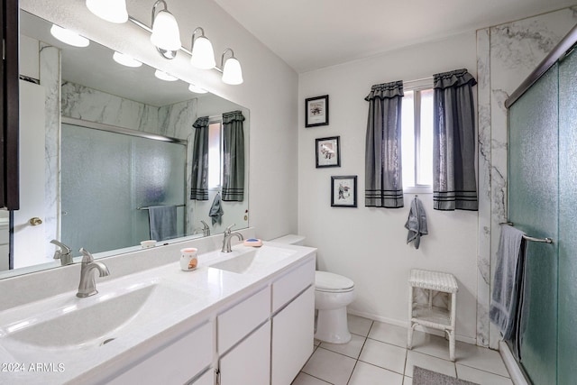 bathroom with vanity, tile patterned flooring, a shower with door, and toilet