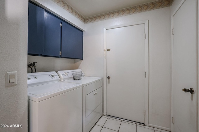 laundry area with separate washer and dryer, light tile patterned flooring, and cabinets