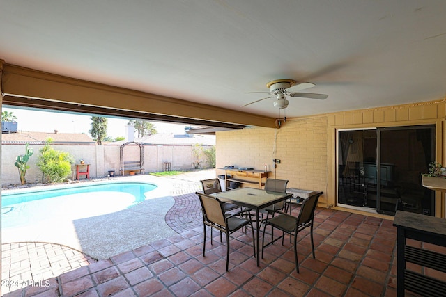 view of patio with a fenced in pool and ceiling fan