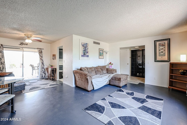 living room featuring a textured ceiling and ceiling fan