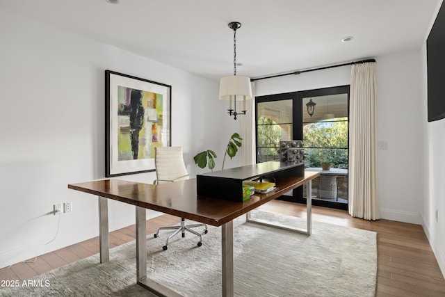 home office with hardwood / wood-style floors