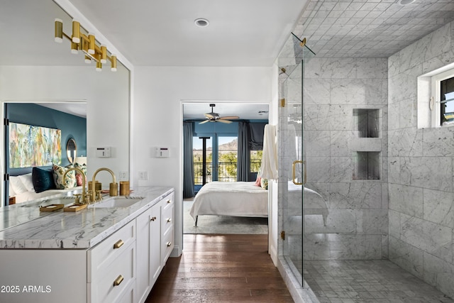 bathroom with wood-type flooring, an enclosed shower, and vanity