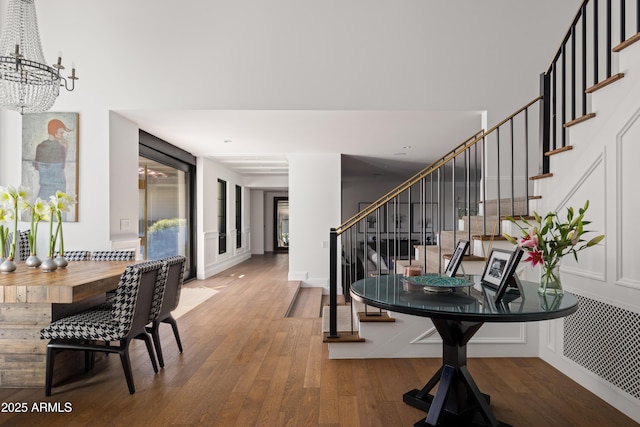 entrance foyer featuring wood-type flooring and a notable chandelier