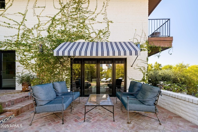 view of patio / terrace with french doors and an outdoor living space