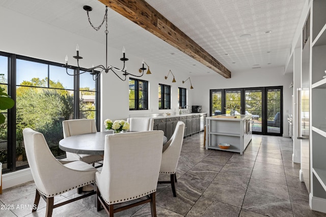 dining area with beam ceiling and french doors