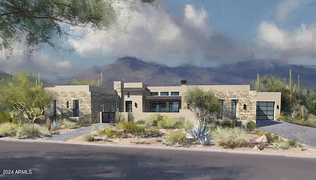 view of front of house with a garage and a mountain view