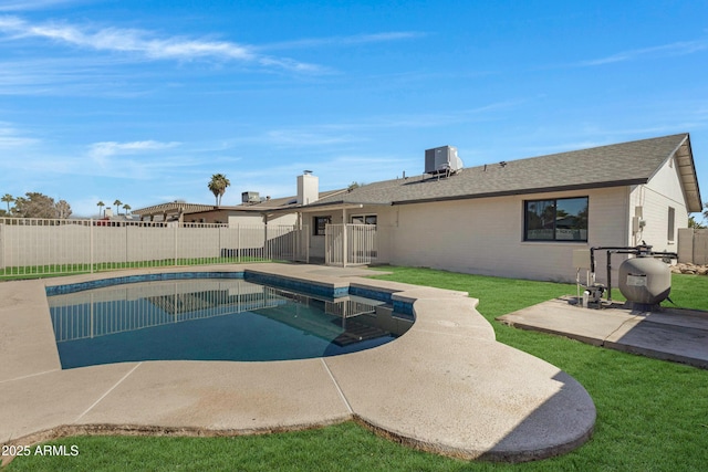 view of pool featuring central AC, fence, a lawn, a fenced in pool, and a patio area