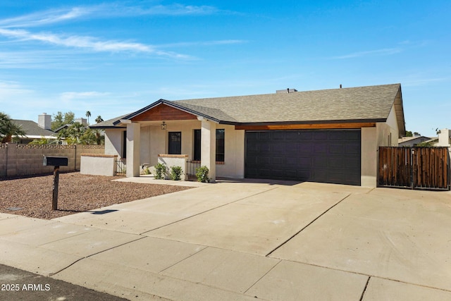 ranch-style home with roof with shingles, stucco siding, fence, a garage, and driveway