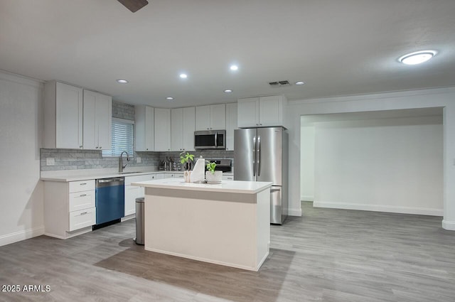 4202 W Purdue Ave, Phoenix, AZ 85051 - kitchen featuring appliances with stainless steel finishes, a sink, light countertops, light wood-style flooring, and recessed lighting