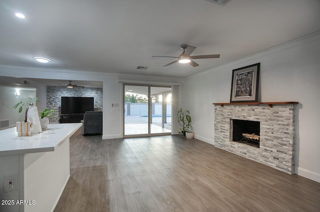 4202 W Purdue Ave, Phoenix, AZ 85051 - unfurnished living room featuring ceiling fan, a fireplace, ornamental molding, baseboards, and wood finished floors