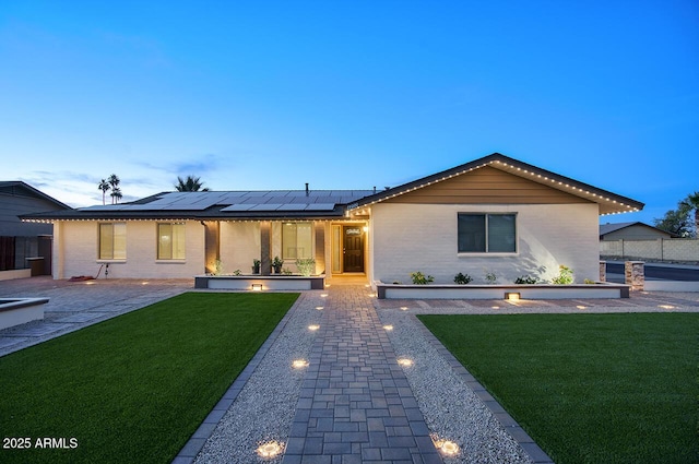 4202 W Purdue Ave, Phoenix, AZ 85051 - single story home with roof mounted solar panels, brick siding, and a patio area
