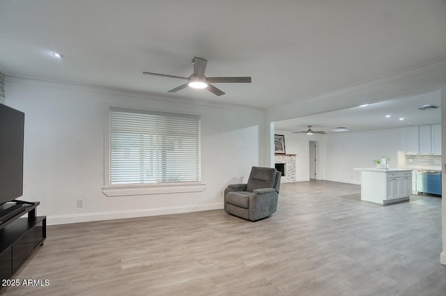 4202 W Purdue Ave, Phoenix, AZ 85051 - sitting room featuring ceiling fan, ornamental molding, baseboards, light wood-style floors, and a fireplace