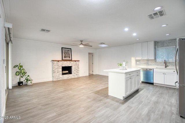 4202 W Purdue Ave, Phoenix, AZ 85051 - kitchen with appliances with stainless steel finishes, ceiling fan, a sink, white cabinetry, and light countertops