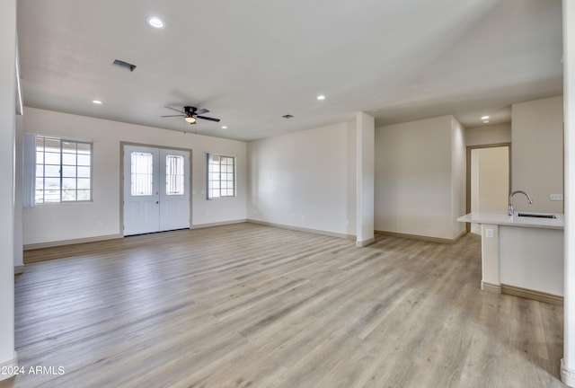 unfurnished living room featuring baseboards, a ceiling fan, recessed lighting, and light wood-type flooring
