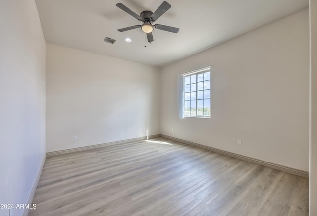 empty room with a ceiling fan, baseboards, visible vents, and light wood-type flooring