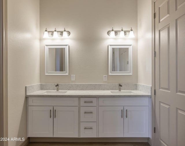bathroom featuring double vanity and a sink