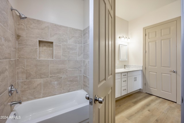 bathroom featuring shower / bath combination, wood finished floors, and vanity