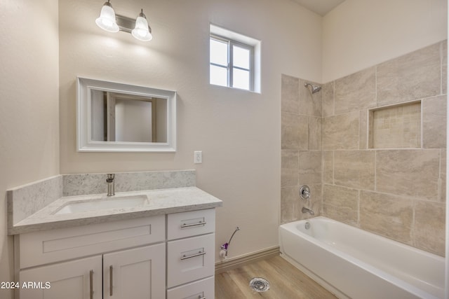 bathroom with vanity, wood finished floors, and shower / bathing tub combination