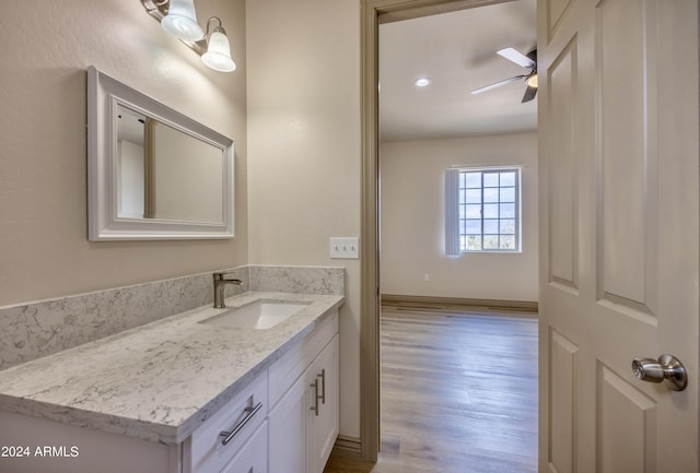 bathroom featuring vanity, ceiling fan, and wood finished floors