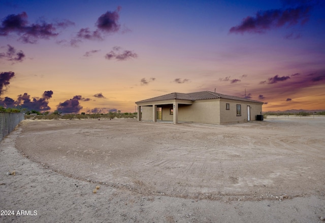 property exterior at dusk with stucco siding
