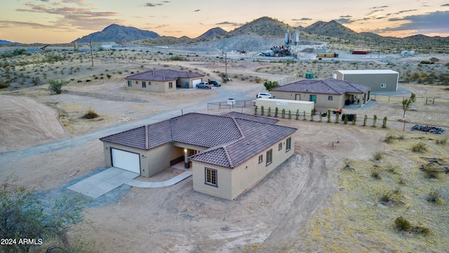 aerial view at dusk with view of desert, a mountain view, and a rural view