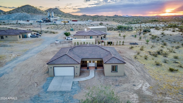 birds eye view of property with view of desert and a mountain view