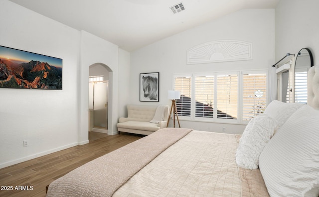 bedroom with high vaulted ceiling and hardwood / wood-style floors