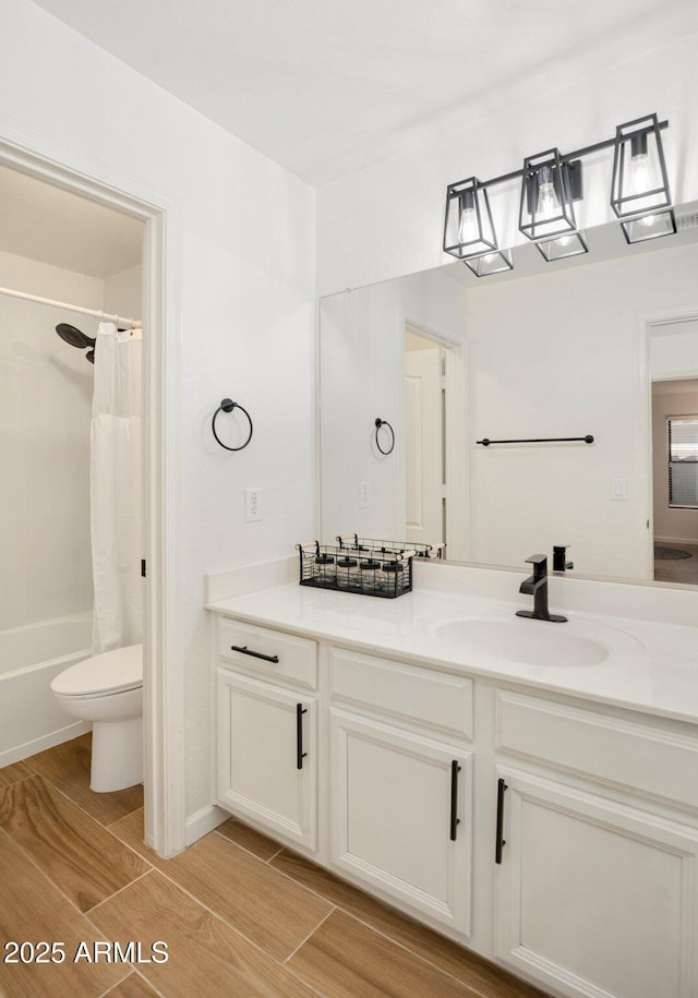 full bathroom featuring shower / bath combination with curtain, vanity, and toilet